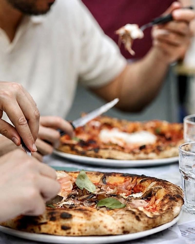 Pizza au jambon cru découpée à table — voir sur Instagram